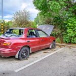 Destroyed,Abandoned,Car,With,Broken,Car,Glasses,,Flat,Tires,And